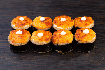 .traditional baked Japanese sushi with salmon, avocado and soft cheese, garnished with sauce. Japanese kitchen. Japanese restaurant. warm sushi