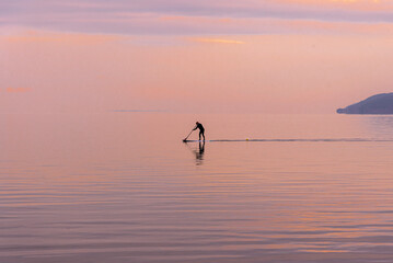 Man on paddle board in lake Vättern, Sweden