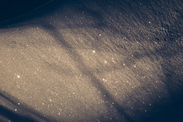Dry snow with sun reflections and shadows.