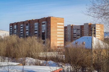 Multi-storey apartment buildings. Low-rise private buildings. Residential area. Winter snow. Ust-Kamenogorsk (kazakhstan)