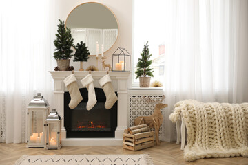 Fireplace in room with Christmas decorations. Interior design