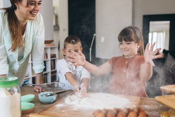 mother with her children baking at home