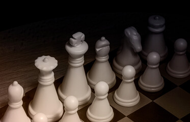 An image of black and white chess pieces on a chessboard