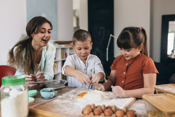 mother with her children baking at home