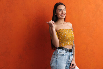 Smiling beautiful young woman presenting copy space