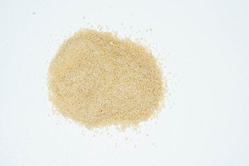 Brown sugar on white background. Copy space