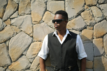 Obraz premium Portrait of young handsome afro black man posing outdoor.