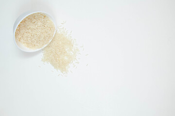 Bowl of long grain white rice, isolated on white background. Copy space.