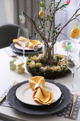 Beautiful Easter table setting with floral decor indoors