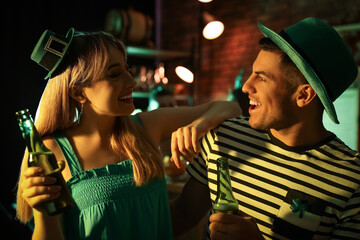 Couple with beer celebrating St Patrick's day in pub