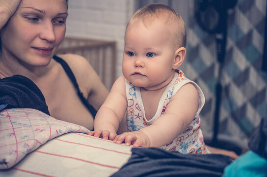 Portrait Of A Mom Looking At A Pensive Little Girl