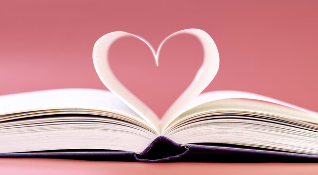 Pages of a book curved into a heart shape. Opened book, pages shaped to form a heart