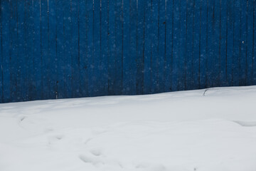 Blue fence and snow. 