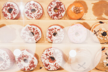 Obraz na płótnie Canvas Assorted tasty colorful donuts on display, close up view. Street food market