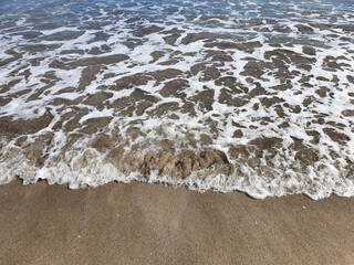 waves on the beach. Tropical beach with yellow sand and blue water. A summer vacation, holiday background of a beach 
