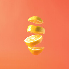 Artistic fresh summer fruit lemon slices floating against a pastel square background.