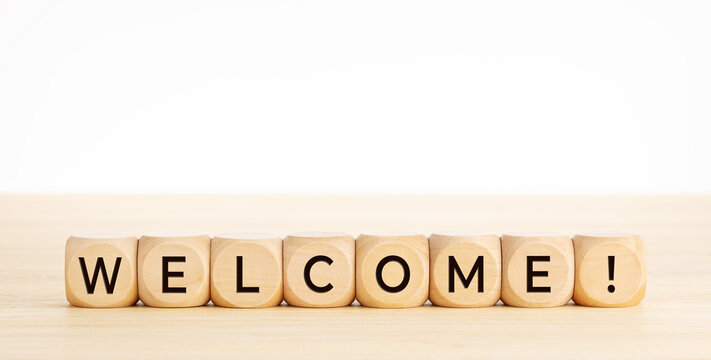 WELCOME word on wooden blocks on wood table