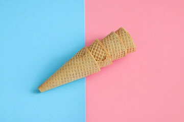 Ice cream cone with abstract blue and pink background. Food concept. Minimalism, mockup, and copy space.