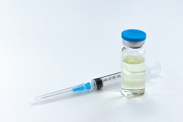 Coronavirus vaccine vial and syringe on white background.