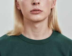 Adam's apple of young man with long blond hair