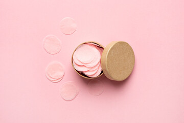 Obraz na płótnie Canvas Open small round gift box with circle confetti on pale pink background . Flat lay, mock-up