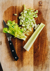 chopped celery on wooden board