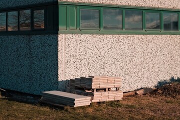 Concrete planks stacked on the lawn in front of an industrial warehouse (Pesaro, Italy, Europe)