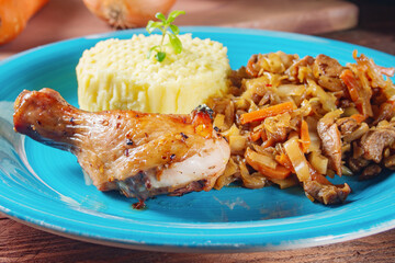 Stewed cabbage with mashed potatoes and baked chicken leg