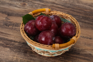 Plum heap in the wooden basket