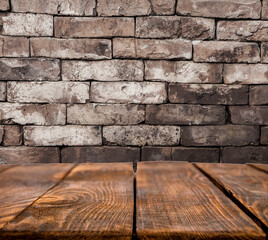 wooden table on a background of brickwork. image in loft style. brown planks on brick texture