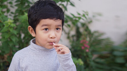 Cute Asian child. Little boy 3 year old smile do a happy face concept