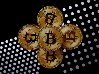 Close up of gold bitcoin on black background with selective focus