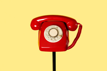 red rotary dial telephone on a stand - obrazy, fototapety, plakaty