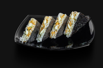freshly made Japanese sushi triangles sandwich served in a black plate