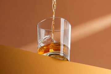 whiskey is poured into a glass