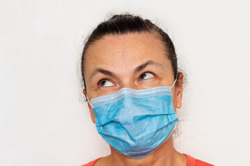 Woman aged in medical mask against coronavirus isolated on white rolled eyes