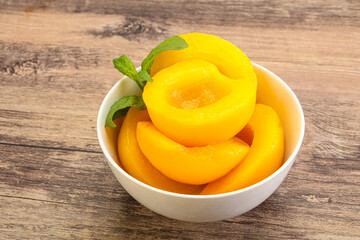 Sweet ripe canned peaches with mint