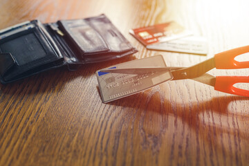Irreversible destruction of a deactivated payment card by cutting with scissors - obrazy, fototapety, plakaty