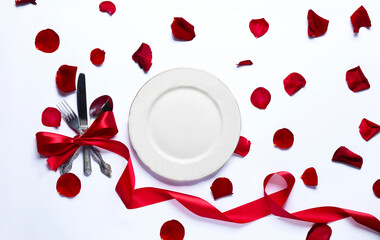 Falling red rose petals on white background