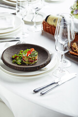 Salad of avokado, seafood, meat, vegetables and pumpkin seeds. Dietary, wholesome and tasty. Banquet festive dishes. Gourmet restaurant menu. White background.