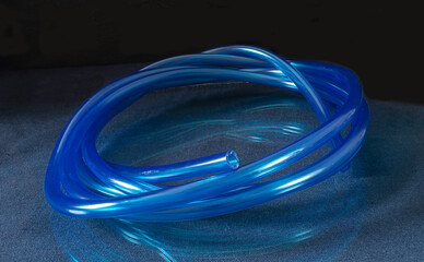 Transparent hose for irrigation in garden on black background