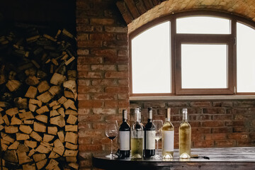 Fototapeta na wymiar Bottles with white and red wine on rustic wooden table