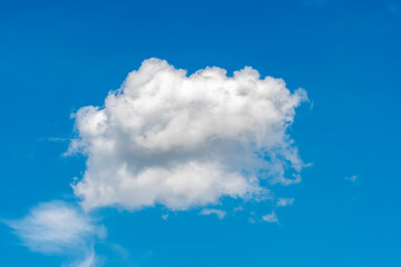 Fototapeta na wymiar One cloud on the blue sky.