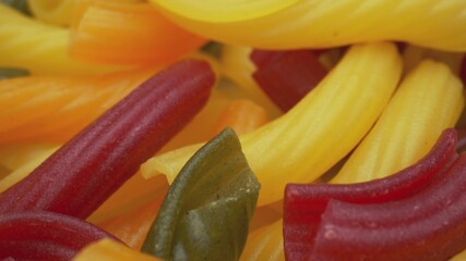 Whole grain colorful pasta in camera motion