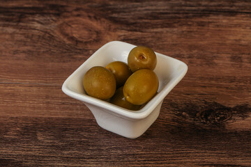 Green pickled olives in the bowl