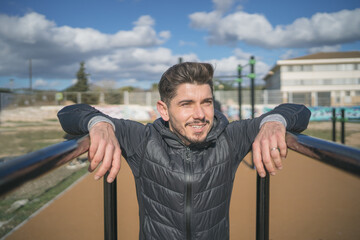 athletic man smiling in a park