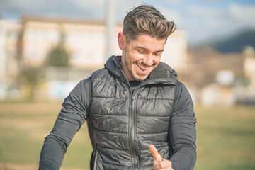 athletic man smiling in a calisthenics park