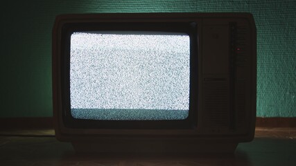 Old TV agains green background