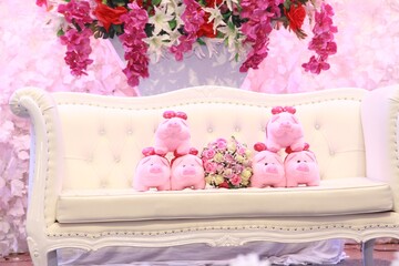 flowers hamdbouquet with pink pigs doll 