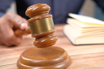 close up of person's hand striking the gavel.